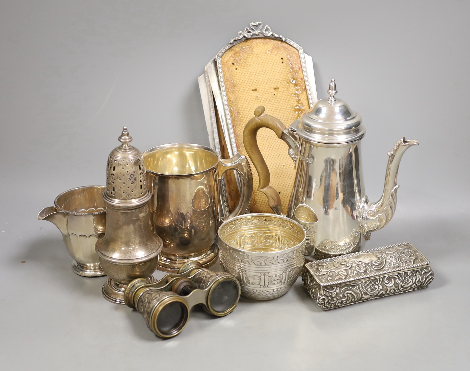 A George V silver coffee pot, London, Carrington & Co 1933, an earlier silver mug by Elkington & Co, a silver sugar caster, cream jug and sugar bowl, a repousse box, pair of silver mounted opera glasses and two plated fr